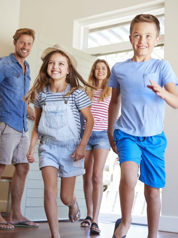 Family Arriving At Summer Vacation Rental